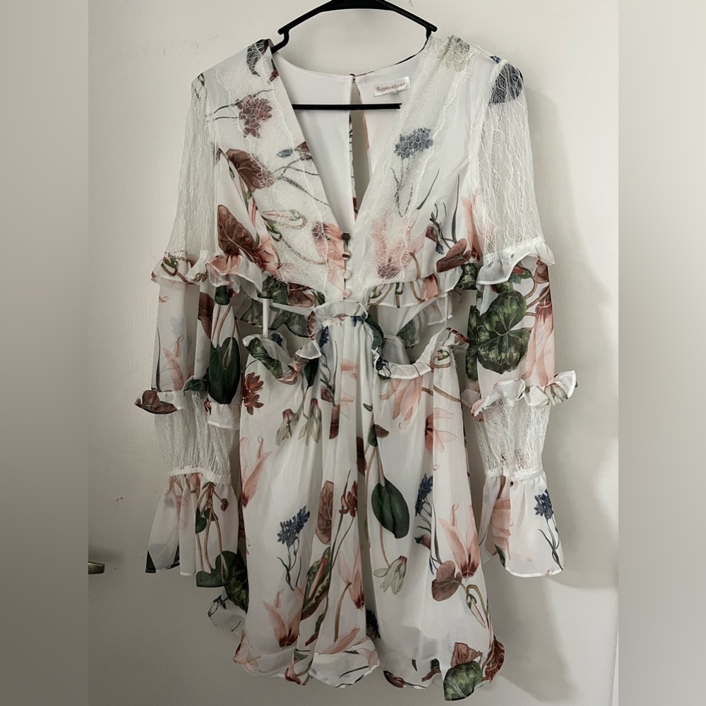 Size medium. Never worn! Dress/romper type outfit. Flowy perfect for spring.